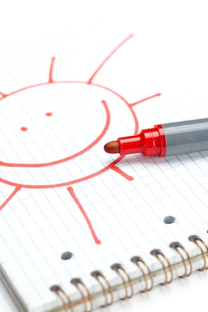 marker and painted the sun on the notebook sheetの写真素材