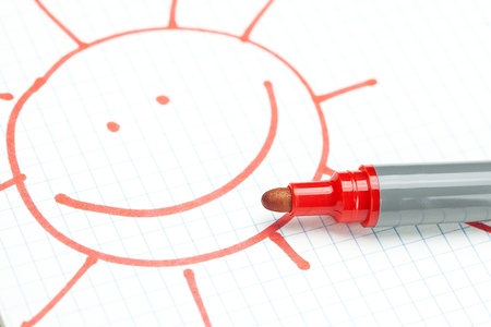 marker and painted the sun on the notebook sheetの写真素材