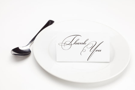 plate with card signed thank you isolated on white