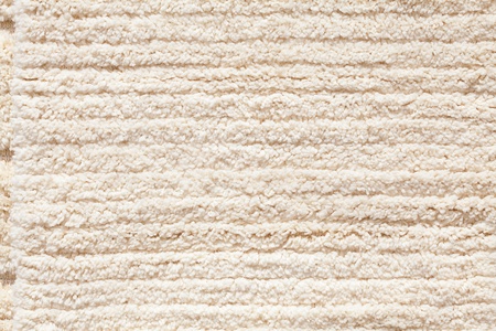 background of the carpet from the sheep wool at the fairの写真素材
