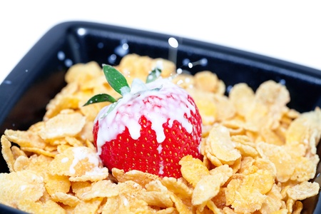strawberry,milk and flakes in a bowl isolated on whiteの写真素材
