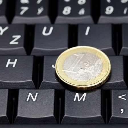 laptop keyboard and coin euroの写真素材