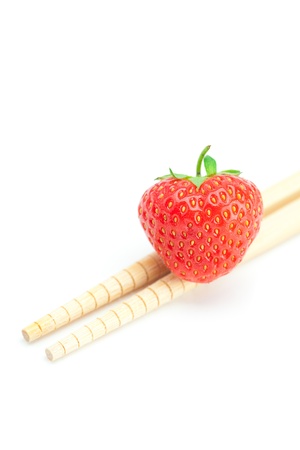 strawberry  and chopsticks isolated on whiteの写真素材