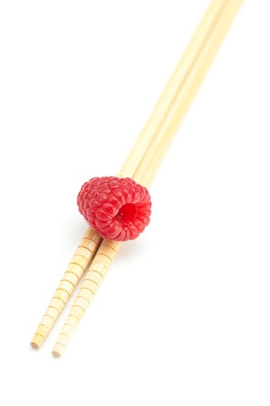 raspberry and chopsticks isolated on whiteの写真素材