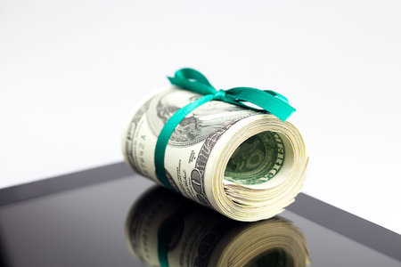 tablet and tube of dollars  isolated on white