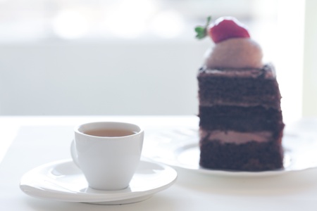 beautiful cake with strawberry and tea on background of streetの写真素材