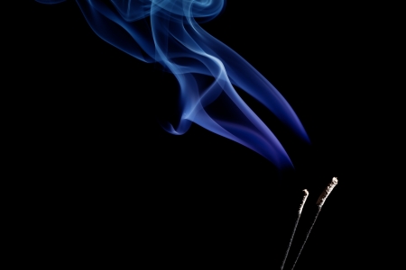 wave and smoke of different colors on black backgroundの写真素材