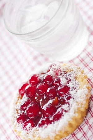 beautiful cake with berries and water on plaid fabricの写真素材
