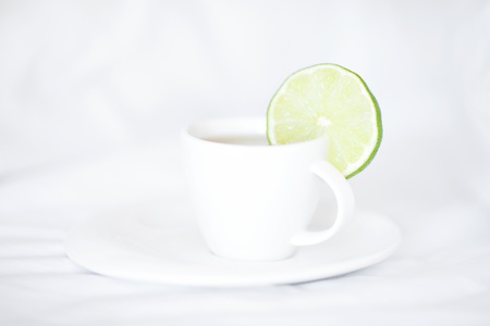 bed with a pillow and a cup of tea の写真素材