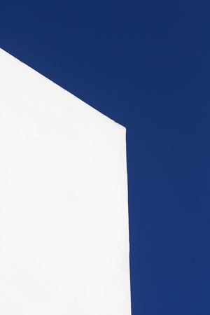 white wall of the building against the blue skyの写真素材
