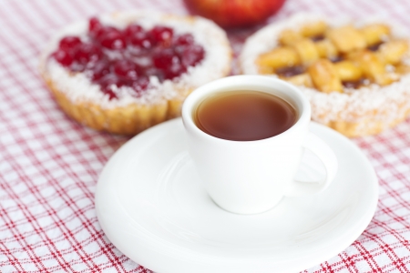 apple,beautiful cake with berries and tea on plaid fabricの写真素材