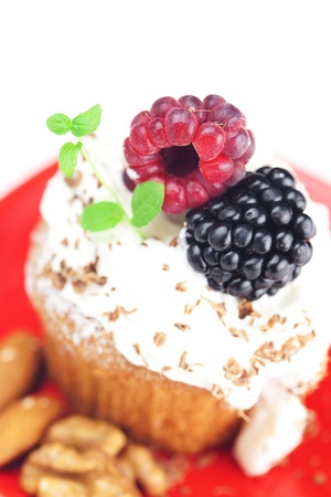 muffin with whipped cream,mint, raspberries, blackberries and nutsの写真素材
