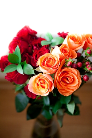 bouquet of colorful roses in a vase on white backgroundの写真素材
