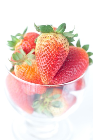 big red strawberries in a glass bowlの写真素材