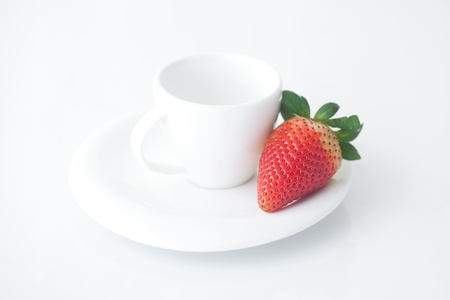 white cup with saucer and strawberriesの写真素材