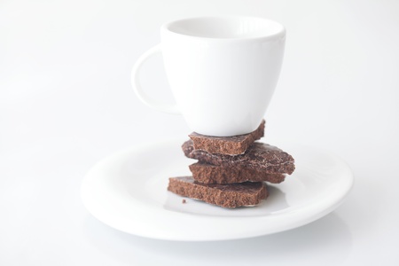 white cup with saucer and chocolate の写真素材