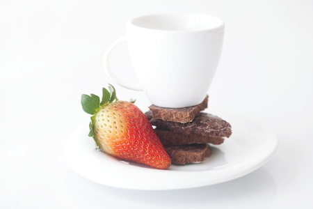 white cup with saucer, chocolate and strawberryの写真素材