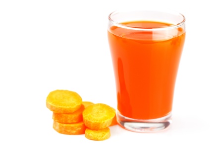 carrot and a glass of carrot juice isolated on whiteの写真素材