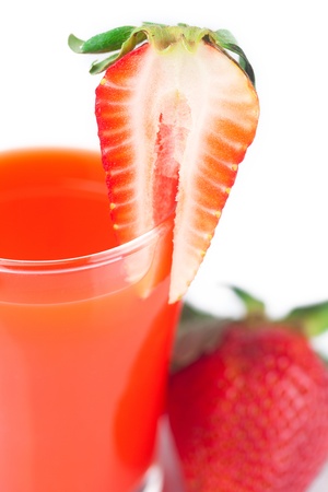 strawberry and a glass of strawberry juice isolated on whiteの写真素材