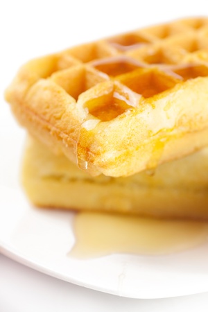 Belgian waffles and honey on a plate  isolated on whiteの写真素材