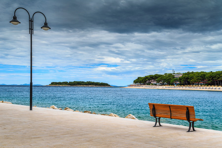 Spectacular relaxing place with romantic promenade and idyllic green island in background,Primosten,Croatia,Europeの写真素材