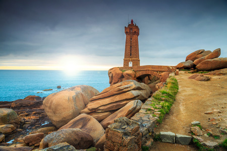 Stunning sunset with lighthouse of Ploumanach Mean Ruz in Perros-Guirec on Pink Granite Coast,Brittany,France,Europeの写真素材