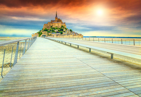 Magical colorful sunset and fabulous Mont Saint Michel cathedral on the island with modern bridge, Normandy, Northern France, Europeの写真素材