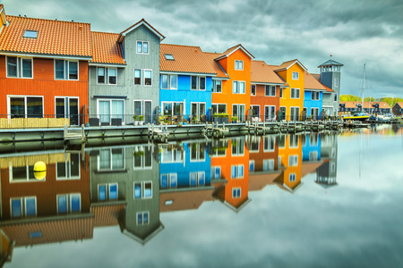 Beautiful colorful buildings on water at haven, Groningen, Netherlands, Europeの写真素材