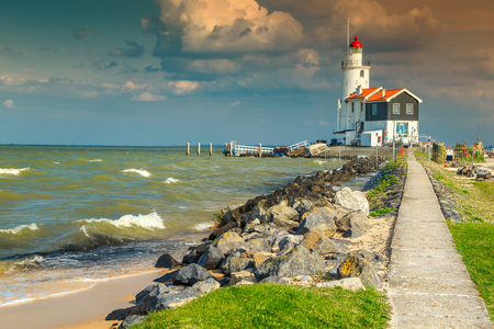 Wonderful lighthouse on the island of Marken and stunning beach with sand, Netherland, Europeの写真素材