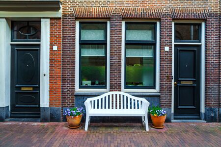 Beautiful entrance and brick house decorated with colorful flowers, Amsterdam, Netherlands, Europeのeditorial素材