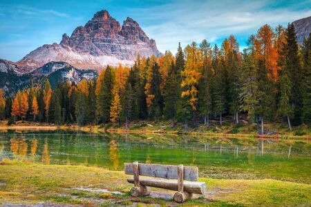 Wonderful autumn landscape, alpine glacier lake and colorful larches, Antorno lake with fantastic Tre Cime di Lavaredo peaks in background, Dolomites, Italy, Europeの写真素材