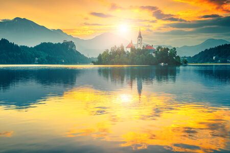 Admirable morning view with small island. Beautiful travel and touristic destination with church and island. Lake Bled and Karavanke mountains in background at sunrise, Bled, Slovenia, Europeの写真素材