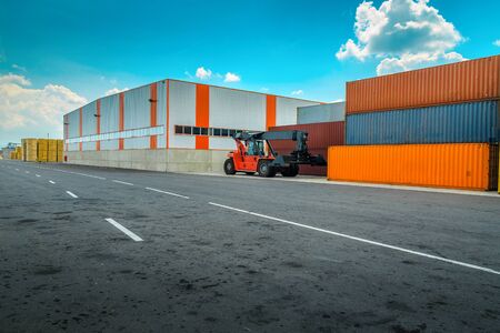 Shipping yard and colorful cargo shipping containers with crane. Container yard with containers box and import export business conceptの写真素材