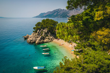Majestic beach and beautiful waterfront with anchored boats, Brela, Dalmatia, Croatia, Europeの写真素材