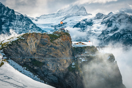 One of the most scenic hiking trail and beautiful viewpoint with metal footbridge on the cliff, First mountain station, Grindelwald, Bernese Oberland, Switzerland, Europeの写真素材