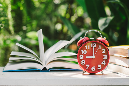 Education concept, Book and Clock with green blur background.,Books stacking.の写真素材