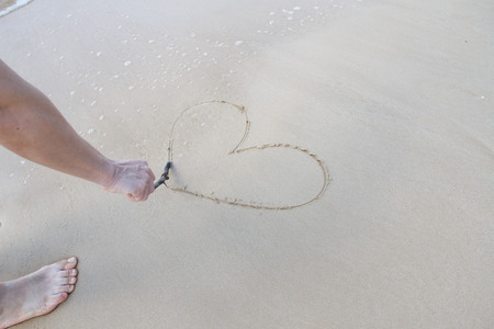 Heart sign on beach. Element of design.の写真素材