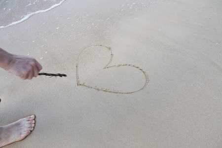 Heart sign on beach. Element of design.の写真素材