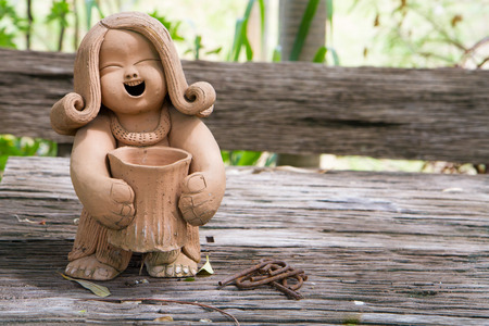 Pottery Lady Doll on the wood tableの写真素材
