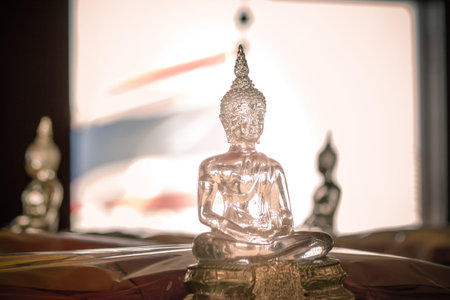 Buddha transparent glass statue close up and blurred
