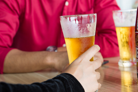 Woman holdingalcohol glass and drinking alcoholの写真素材