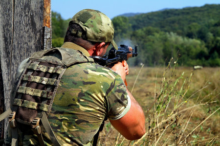 Rapid response team soldier shooting with Kalashnikov assault rifle during a training exercise.