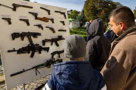 Uzhgorod, Ukraine - 14 October 2016: Local residents consider the exhibition of small arms during the celebration of Defender of the Fatherland Day. This day Ukraine celebrates the Day of Defender of the Fatherland.のeditorial素材