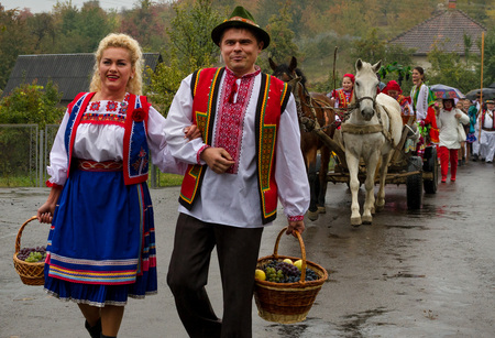 Village Bobovysche (Mukachevo district, Transcarpathian region, Ukraine) - 2016 October, 16: Locals in Hutsul national costumes with baskets of grapes go to etnofestyval "Bobovyschanske Grono-2016". Etnofestival visitors can review with the local traditioのeditorial素材