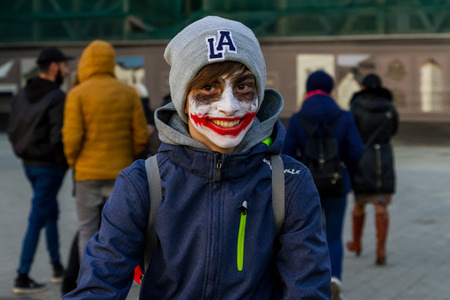 Uzhgorod, Ukraine - October 31, 2016: Funny Halloween celebration participant in Zombie form of walking in the city center.のeditorial素材