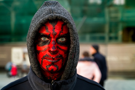 Uzhgorod, Ukraine - October 31, 2016: Funny Halloween celebration participant in demon form of walking in the city center.のeditorial素材