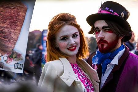 Uzhgorod, Ukraine - October 31, 2016: Participants in the celebration Funny Halloween in the image of of porcelain dolls and a demon waiting for the start of the procession of representatives of evil forces in the city center.のeditorial素材