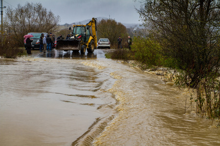 Zarichevo, Ukraine - November 7, 2016: Local residents monitor the road, which floods the water released from the banks of the river. Over the weekend, fell out in Transcarpathia two monthly rainfall.のeditorial素材