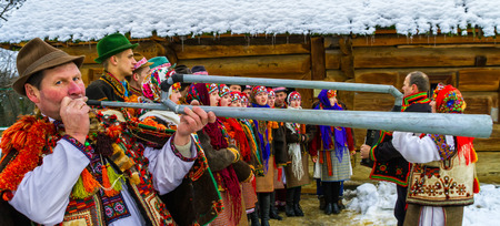 Uzhgorod, Ukraine - January 15, 2017: Member of folklore band plays on trembita during the seventh ethnic festival Christmas Carols in the old village. During the festival, visitors can familiarize with a variety of Christmas customs, caroling and celebraのeditorial素材