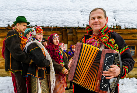 Uzhgorod, Ukraine - January 15, 2017: Member of folklore band plays accordion during the seventh ethnic festival Christmas Carols in the old village. During the festival, visitors can familiarize with a variety of Christmas customs, caroling and celebratiのeditorial素材